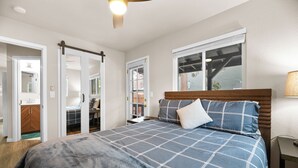 A bedroom with a large bed, a wooden headboard, a window with blinds, and a ceiling fan. - The Maple Lane Hideaway (Sugarloaf)