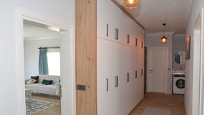 A modern apartment with a living area, a kitchen, and a laundry room. - VILLA WITH LAKE AND FOREST VIEW IN DALYAN2 (Akcakavak)