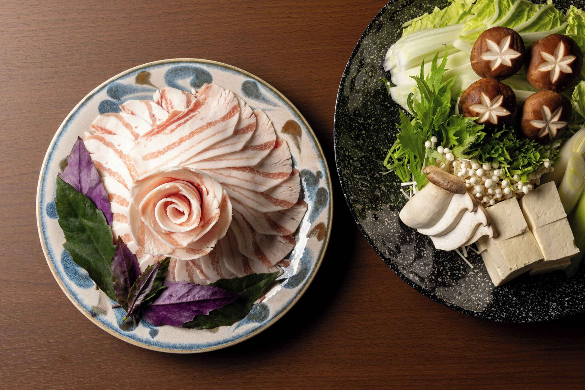 Two plates of food with various garnishes.