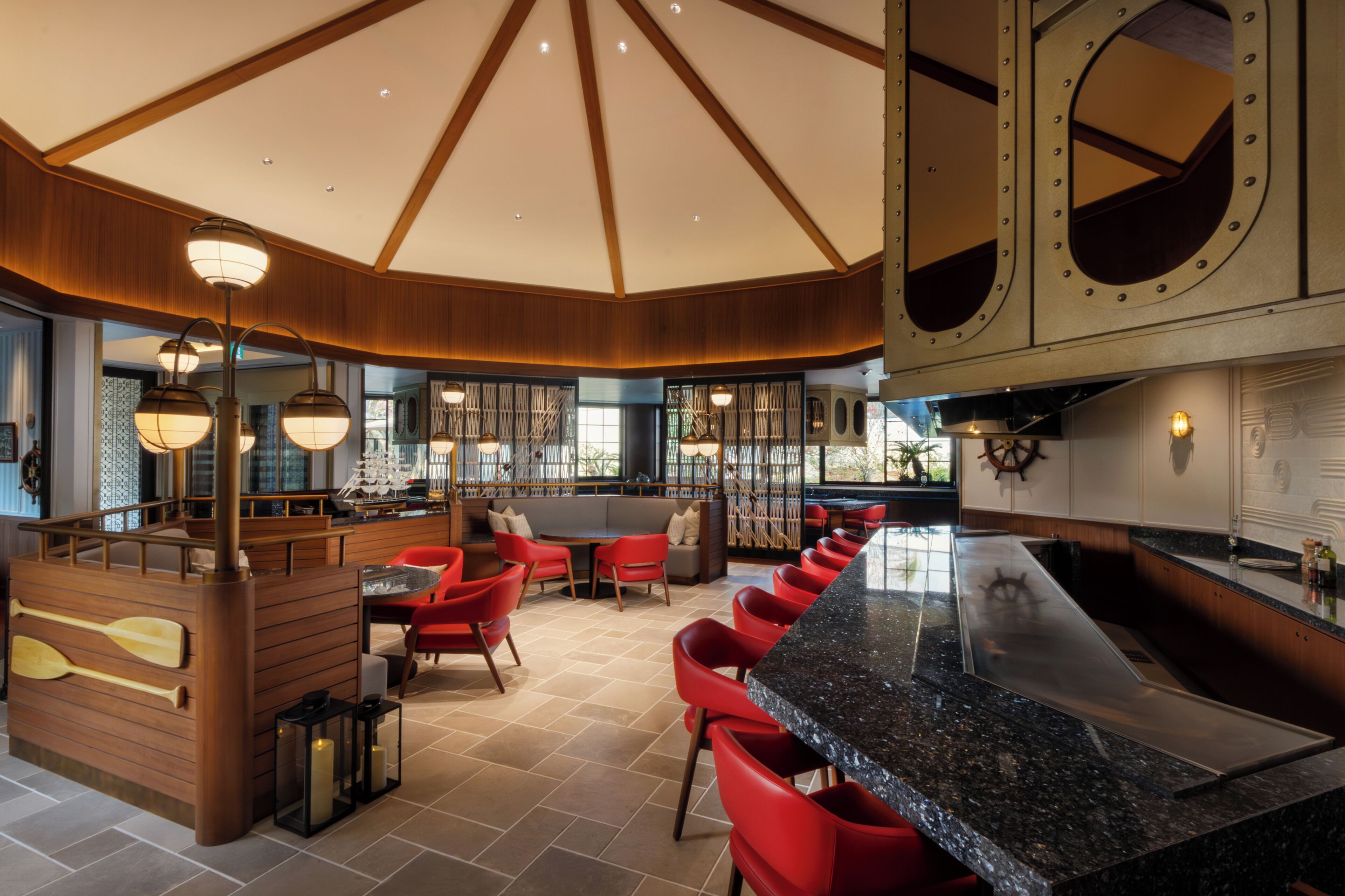 A modern interior with a bar area, seating, and nautical-themed decor.