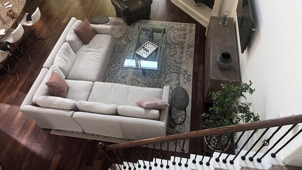A living room with a sofa, coffee table, and fireplace. - Woodlands House. 8 People, Restaurants, Movie Theater, HEB, Parks and Walkways. (Tomball)