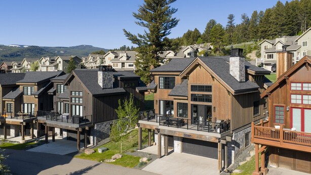 A residential area with modern houses featuring balconies and large windows.
