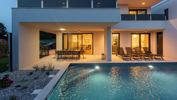 A modern two-story house with a swimming pool, outdoor seating, and a well-lit patio area. - Villa Villa Mattia (Istria - Novigrad) (Novigrad)
