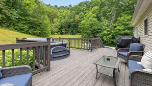 A wooden deck with outdoor furniture, including a sofa and chairs, overlooking a lush green landscape. - Hatton Hideaway at Red River Gorge! Pool / Hot Tub / Arcade Game Room (Stanton)