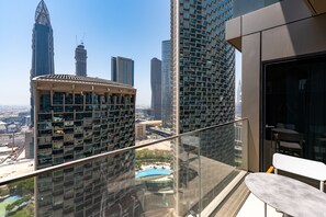A high-rise building with a glass balcony, offering views of a cityscape with several skyscrapers. - 2BR Address Dubai Opera | Walk to Mall, Burj Khalifa & Opera (Dubai)