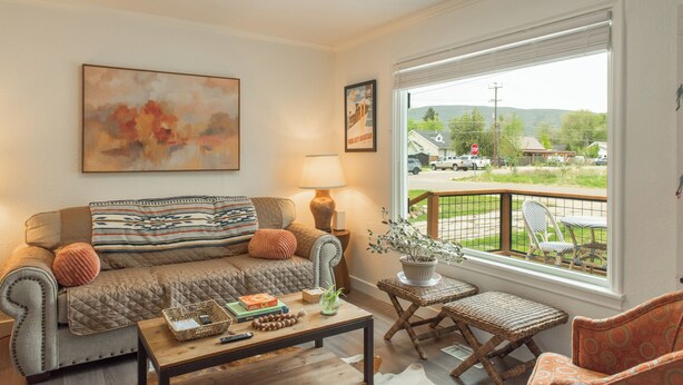 A cozy living room with a sofa, a coffee table, and a view of the outside. - Heber base camp, sleeps 7, fire pit, pets ok, AC (Heber City)
