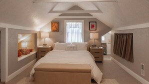 A bedroom with a large bed, two bedside tables, a window with sheer curtains, a brown curtain on the right, and a small picture on the wall. - Heber base camp, sleeps 7, fire pit, pets ok, AC (Heber City)