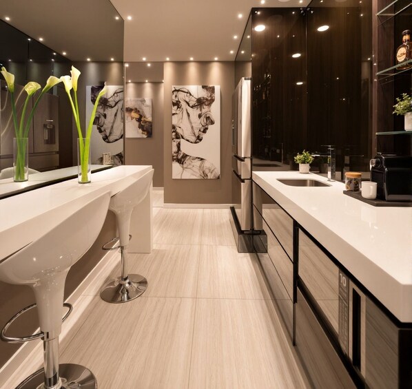 A modern bathroom with a double sink vanity, a large mirror, and a decorative wall with abstract art.