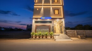A modern two-story building with a sign for 'fab hotels' and 'RK DHAM' at the entrance. - Fabhotel Rk Dham (Vrindavan)