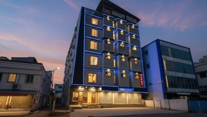 A multi-story hotel with a modern facade, multiple balconies, and a prominent entrance with a staircase. - FabHotel Golden Comforts (Bengaluru)