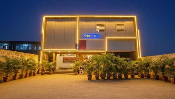 A modern hotel with a flat roof, a central entrance, and a signboard. - Fabhotel Galaxy Inn (Mumbai)