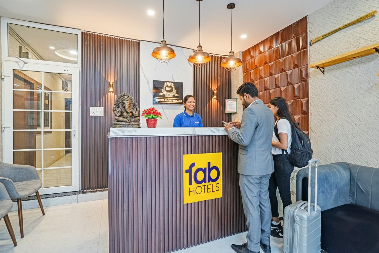 A hotel reception desk with a modern design, including a wooden panel wall, a reception counter, and a sign that reads "fab hotels".