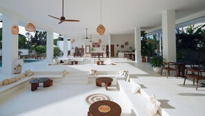 A spacious, modern living area with a pool, outdoor seating, and a dining area. - Serendipity Legian (Legian)