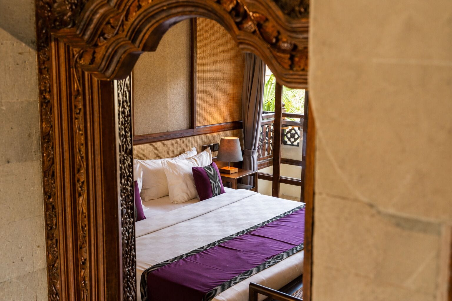 A bed with a headboard, pillows, and a blanket.