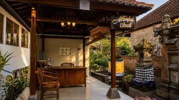 A traditional wooden structure with a sign reading 'Mambul Ubud.'
