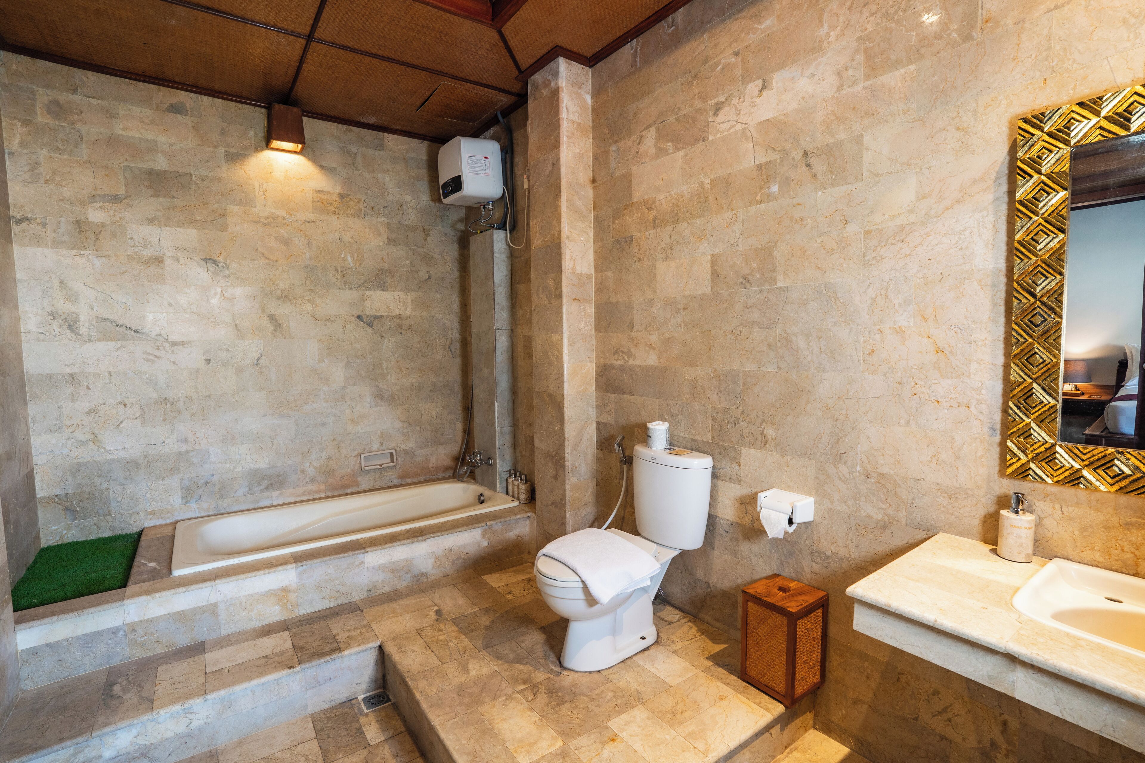 A bathroom with a bathtub, toilet, and sink.