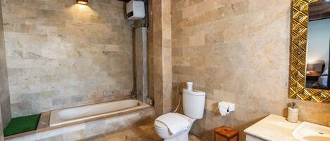 A bathroom with a bathtub, toilet, and sink.
