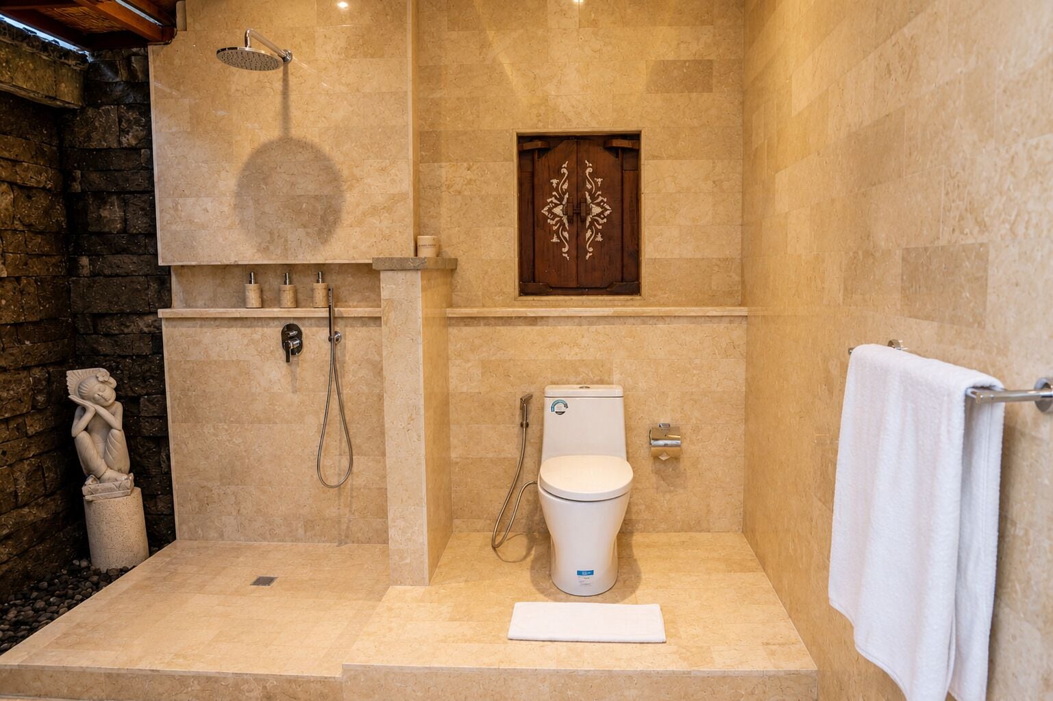 A bathroom with a shower, toilet, and a towel rack.