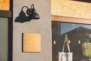 A wall-mounted light fixture and a sign with the text "WANDERLUST STAY".