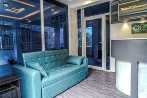 Deluxe Room | Living area | 32-inch LED TV with satellite channels