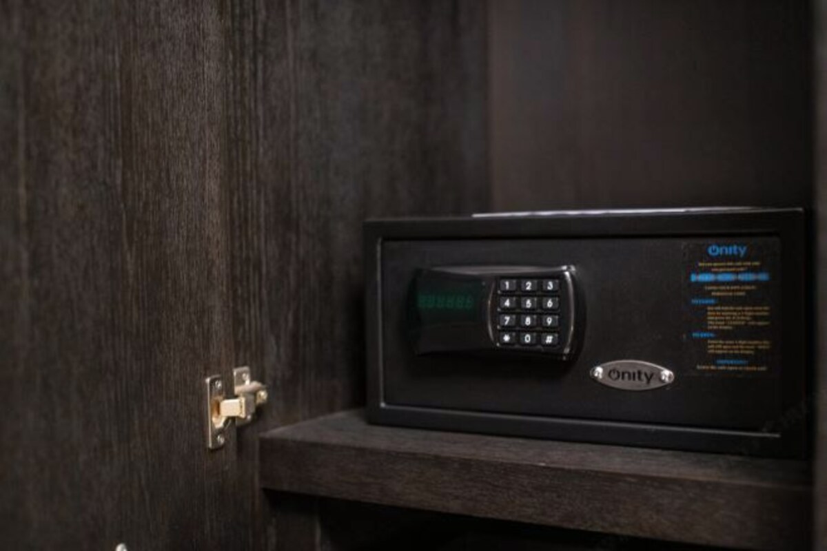 A black safe with a keypad and the Onity logo on a wooden surface.