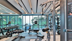 A modern gym with weightlifting equipment, benches, and dumbbells. - A303 - 1 Bedroom Serviced Apartment Partial Sea View at Ao Nang Beach (Tambon Ao Nang)