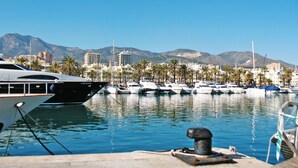 A marina with boats docked, a clear sky, and a mountainous backdrop. - Pueblo Quinta by Interhome (Benalmádena Costa)