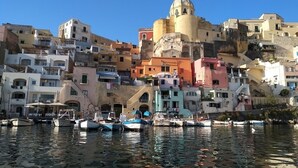 Un pueblo costero con edificios coloridos y barcos amarrados en el puerto.