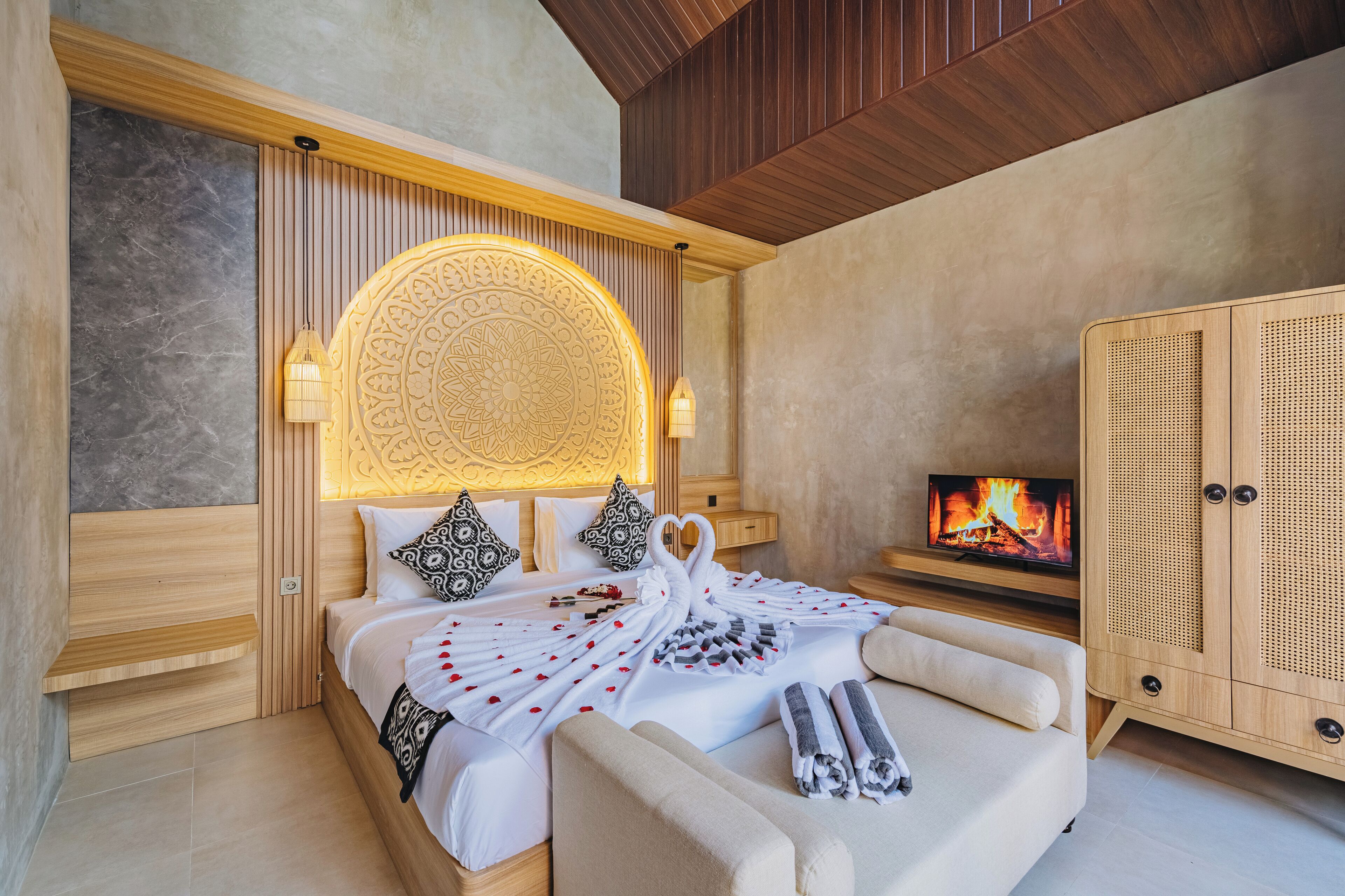 A modern bedroom with a bed, a TV, and a wooden wardrobe.