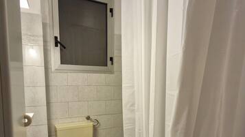 A small bathroom with a toilet, sink, and bathtub.