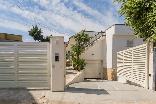 A gated residential area with a staircase leading to a garage.