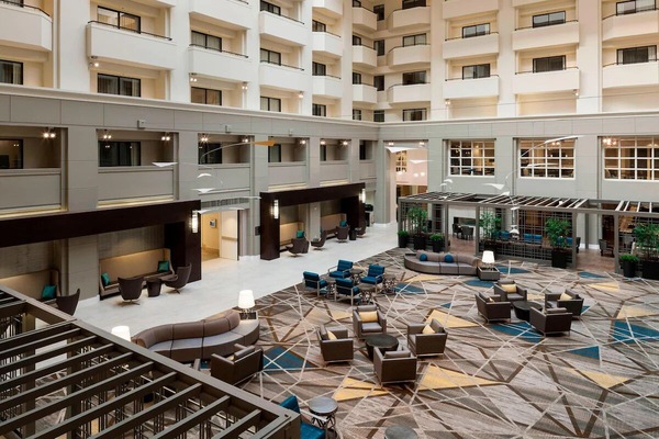 Step into a soaring atrium lounge with stylish seating.