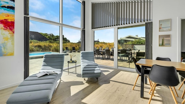 A modern interior with large windows, a pool view, and outdoor seating. - Gorgeous home in Ringkøbing with sauna (Ringkøbing)