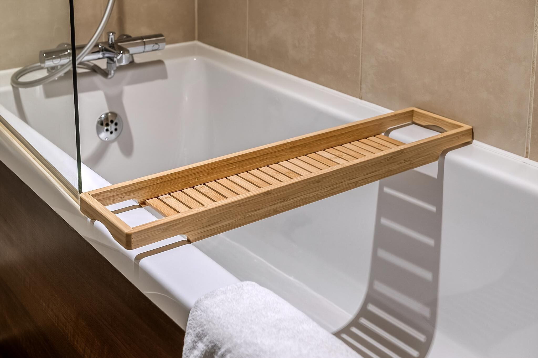 A bathtub with a wooden tray.