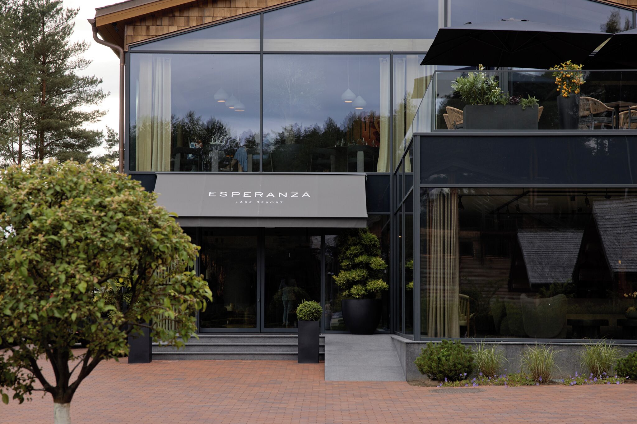A modern building with a large glass facade, labeled "Esperanza Lake Resort."