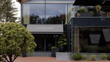A modern building with a large glass facade, labeled "Esperanza Lake Resort."
