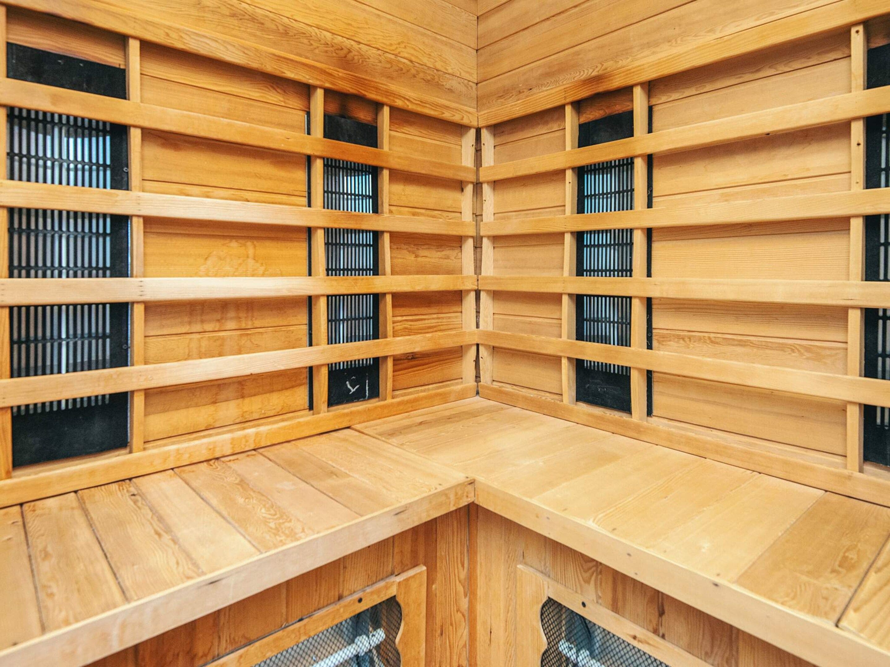 A sauna with wooden walls and multiple benches.