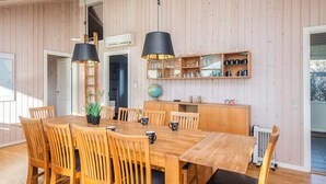 A wooden dining table with chairs, a globe, and a shelf with kitchenware. - 4 Star Holiday Home in Hemmet (Hemmet)
