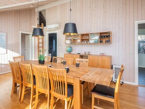 A wooden dining table with chairs, a globe, and a shelf with kitchenware. - 4 Star Holiday Home in Hemmet (Hemmet)