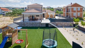 A residential property with a swimming pool, a trampoline, and a children's play area. - Villa Alba Zadarvillas (Pakostane)