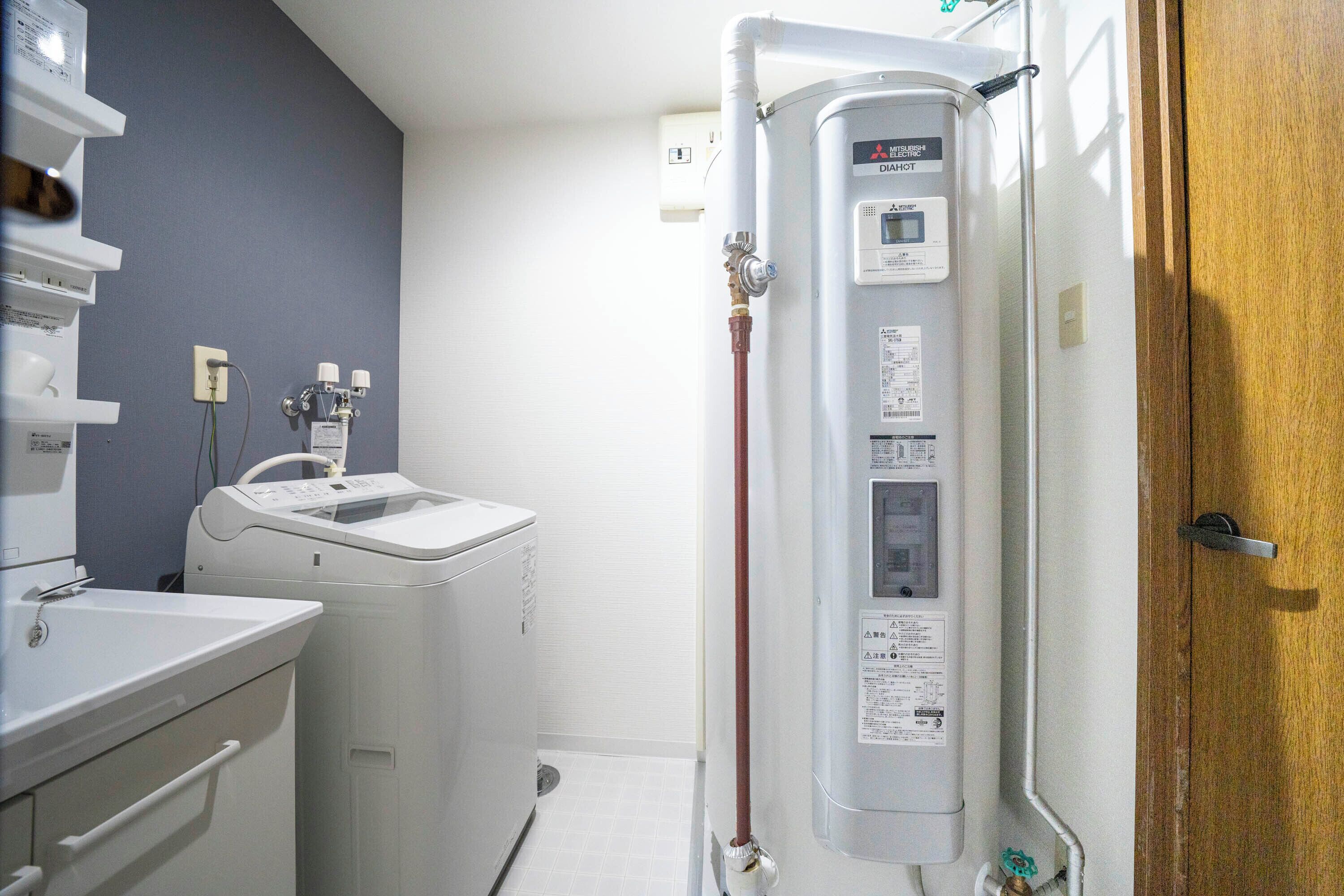 A laundry room with a washing machine, dryer, and a water heater.