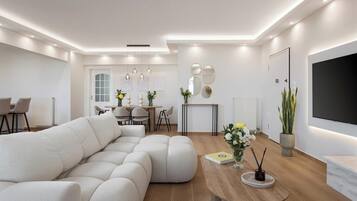 Departamento Deluxe, balcón, vista al mar | Sala de estar | Smart TV de 65 pulgadas con canales digitales y Netflix