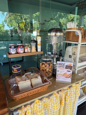 A breakfast display with mixed berry spread, strawberry spread, orange spice, and a jar of nuts. - SP RESORT (Wichian Buri)