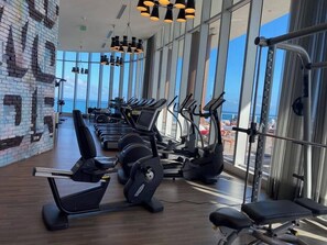 A gym with treadmills, elliptical machines, and weight machines.