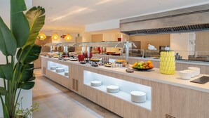 A buffet area with multiple food stations, a glass railing, and a modern interior design. - SH Jávea (Jávea)