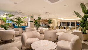A spacious lobby with modern seating, large potted plants, and a well-lit ceiling. - SH Jávea (Jávea)