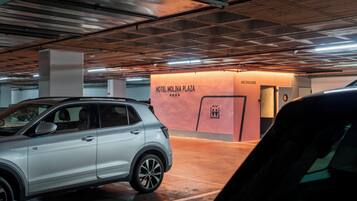 Uma garagem de estacionamento com um SUV branco estacionado em uma vaga.