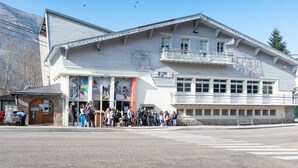 A large building with a prominent entrance and a balcony.