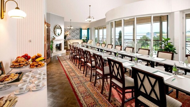 A conference room with a long table, chairs, and a buffet table with food and drinks. - Hotel Great Polonia Kraków Airport (Modlniczka)