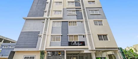 A multi-story building with a modern design, featuring a prominent 'Collection' sign on the facade.